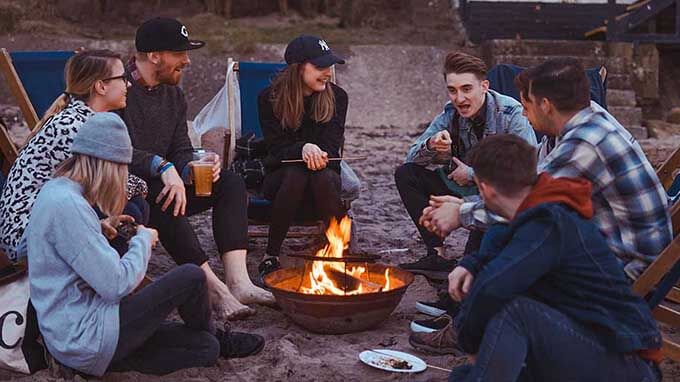 people talking around a fire