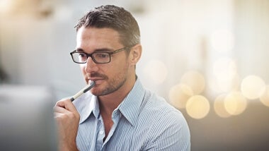 man with pen at desk man-with-pen-at-desk