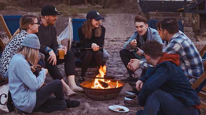 people talking around a fire