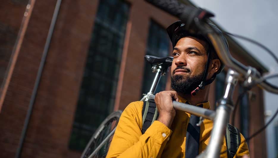 Cyclist holding bicycle
