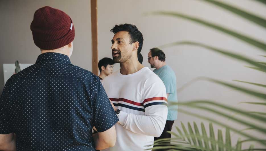 Diverse people talking in groups during a break